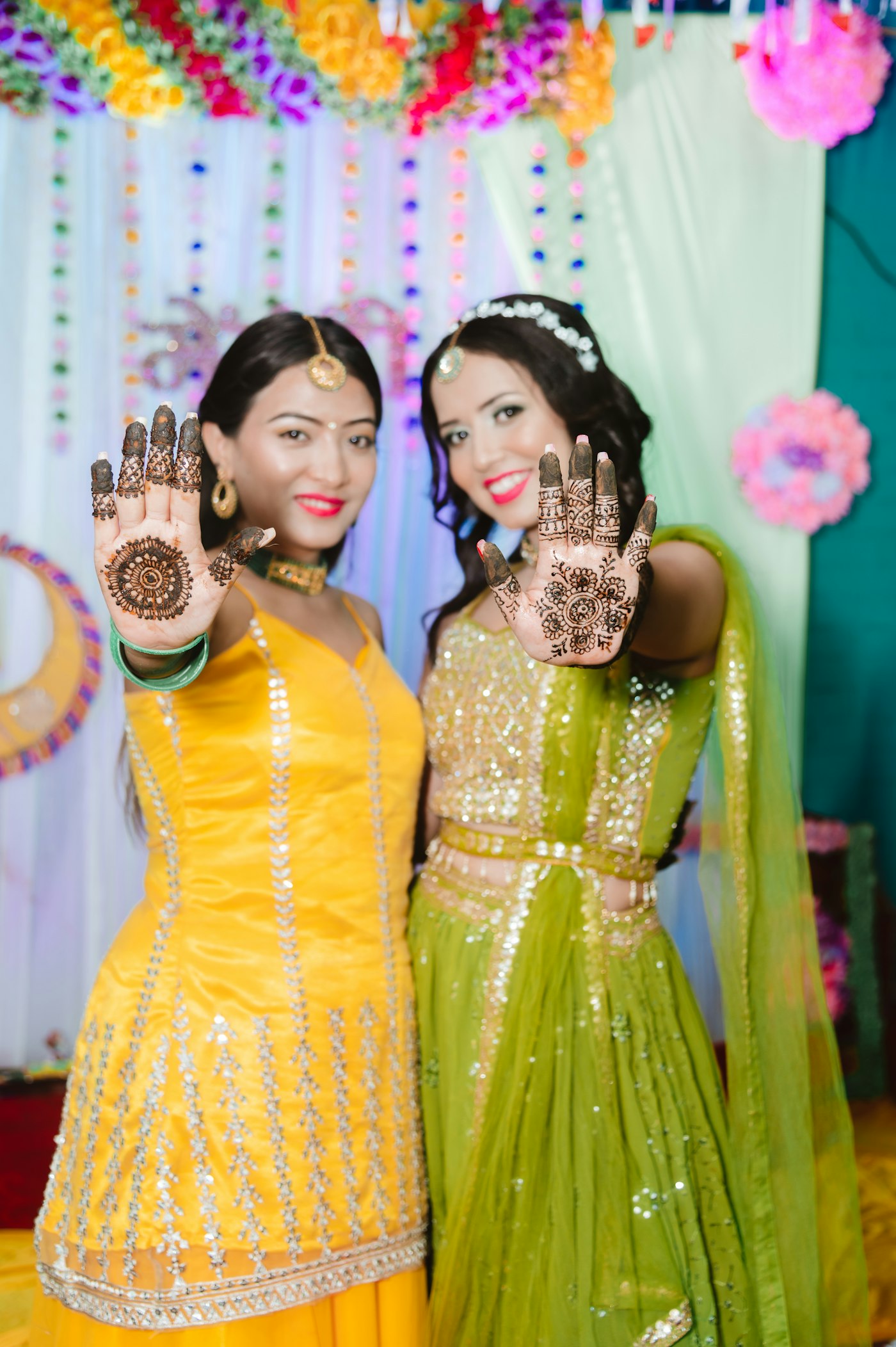 Friends showing their mehendi at the celebration