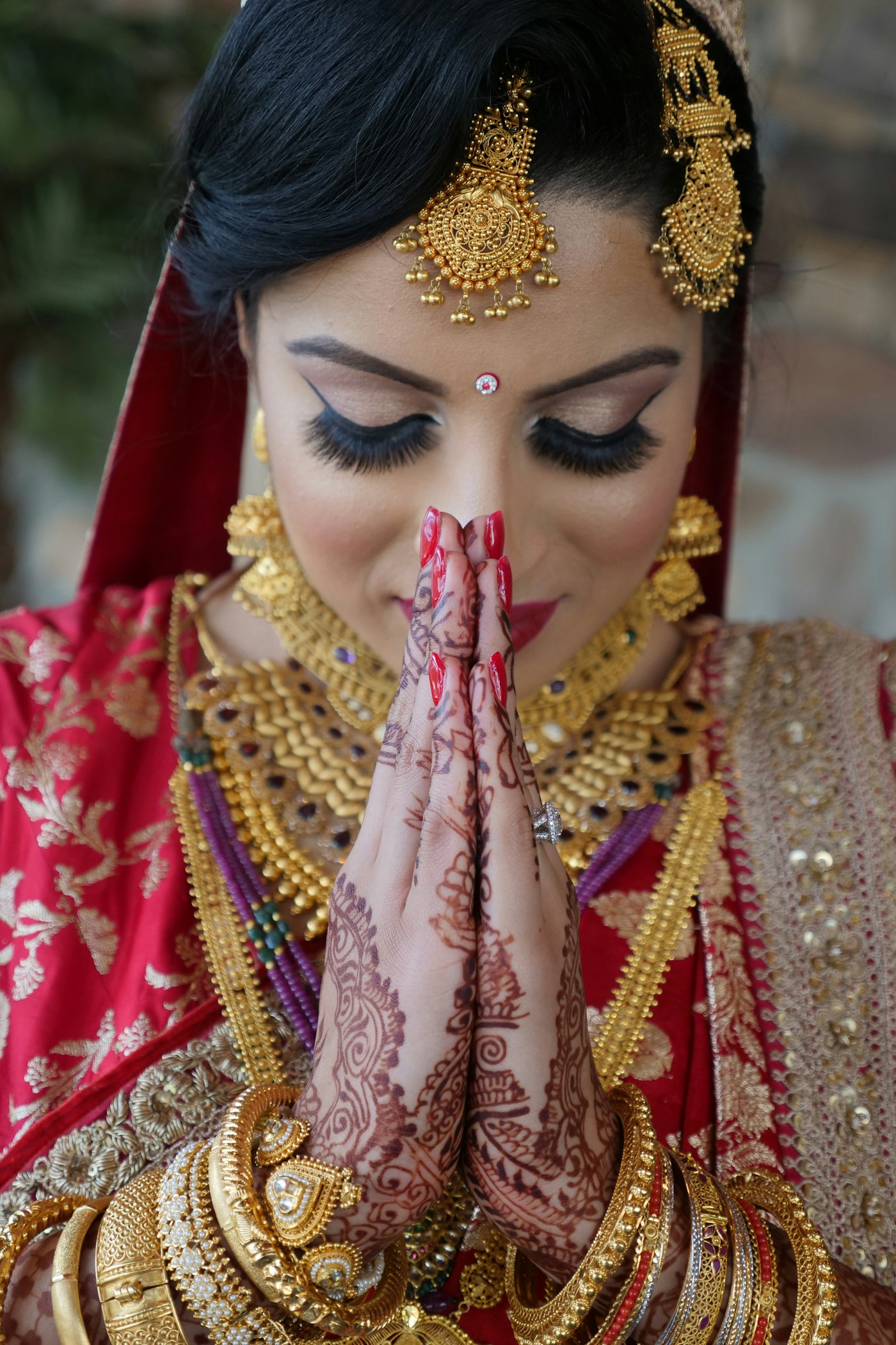 Bride with mehendi hands folded in namaste