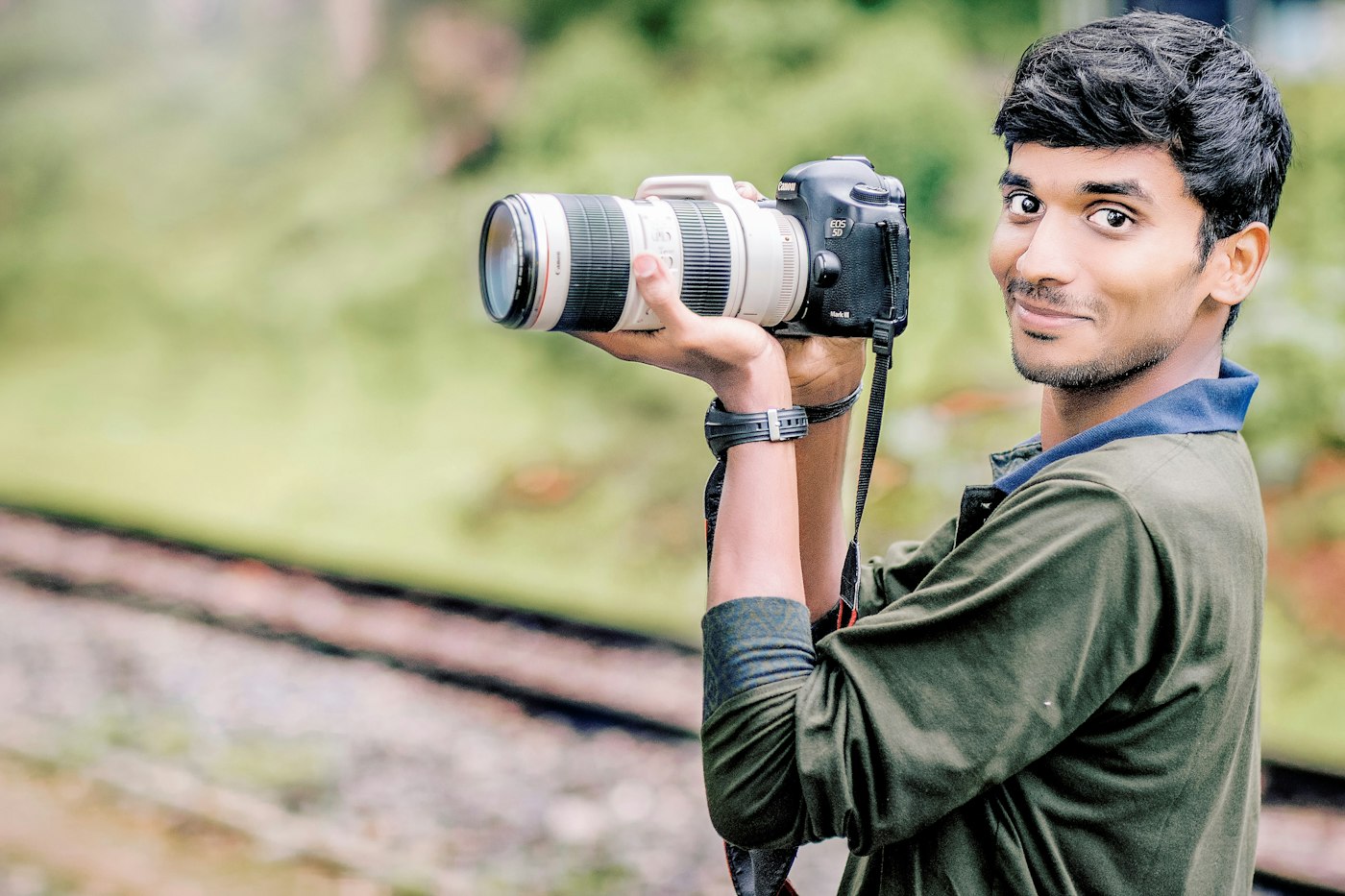 Photographer holding a camera with a telephoto lens